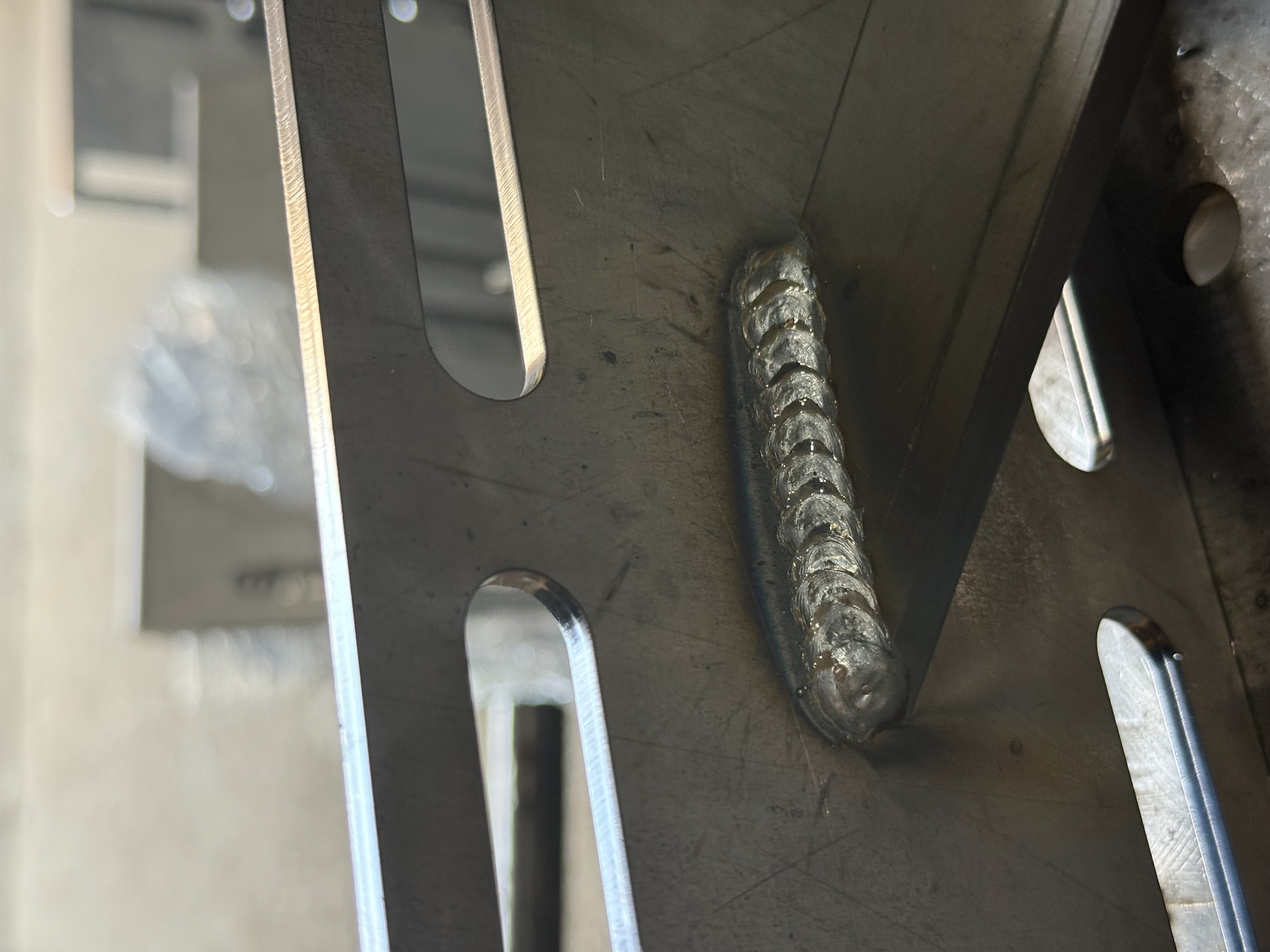 Close-up of weld bead on steel bracket