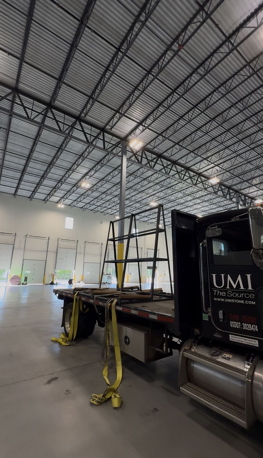 Steel slab A-frame mounted on a stone company flatbed